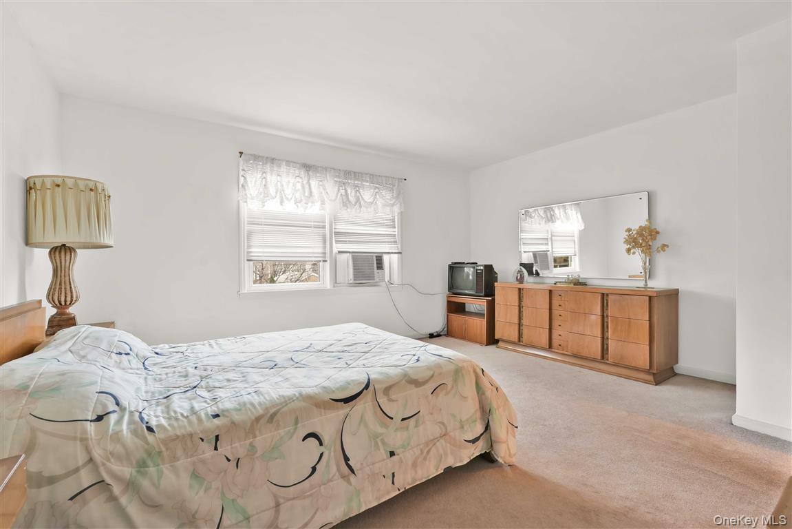 84-92 Austin Street Queens, NY 11415 - Photo 17 of 40 a bedroom with a bed and a large window