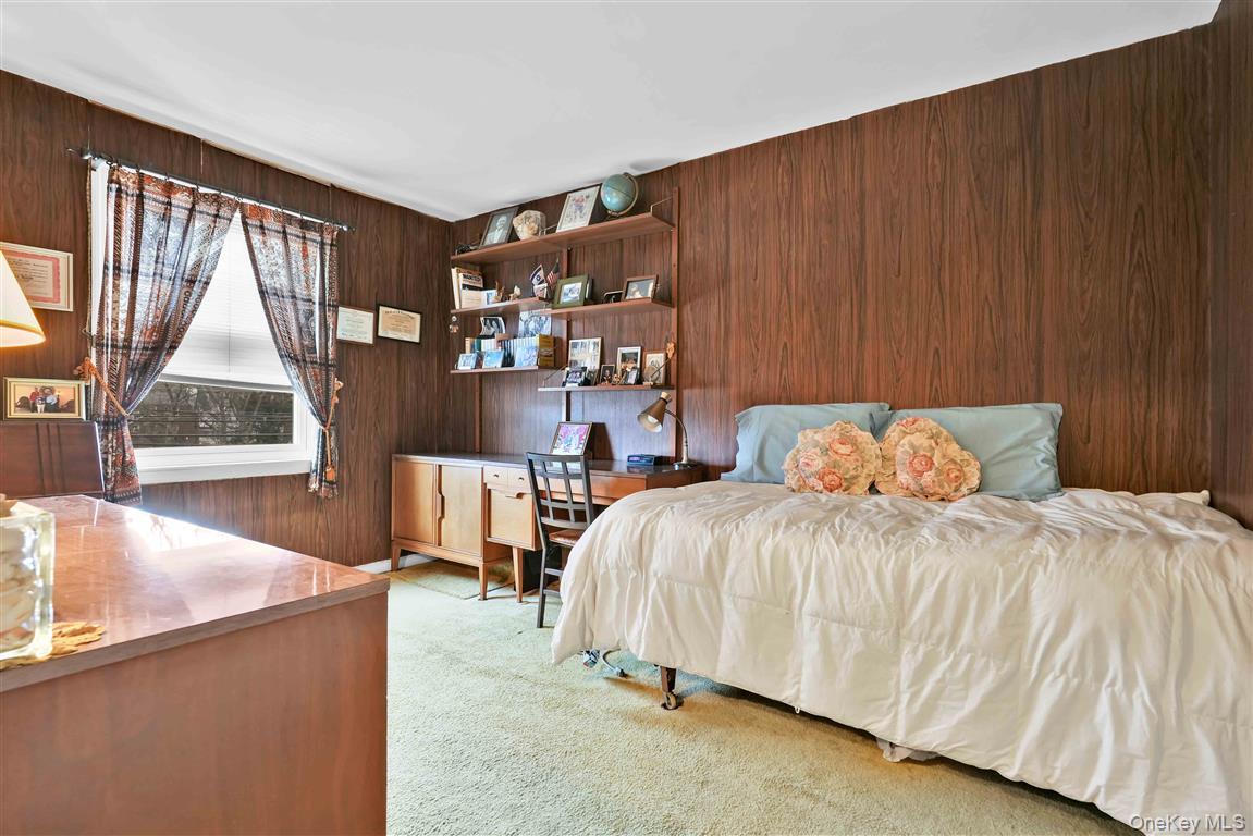 84-92 Austin Street Queens, NY 11415 - Photo 18 of 40 a bedroom with a bed and window