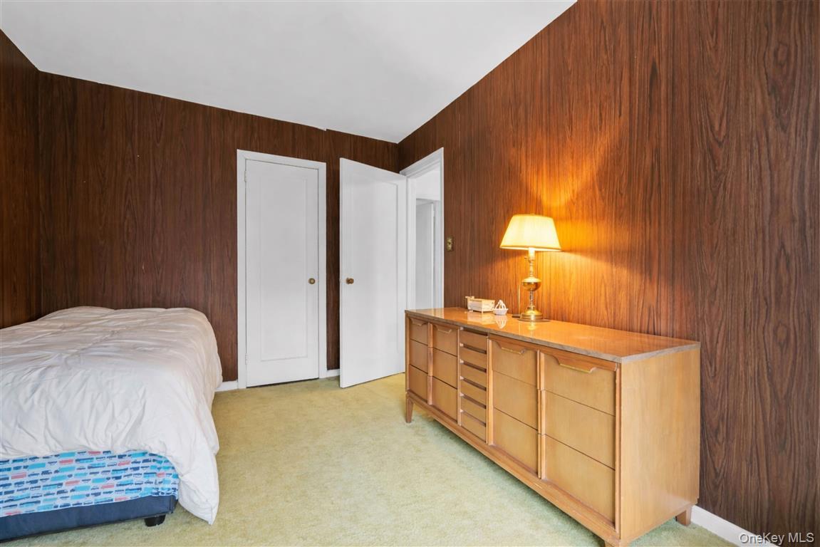 84-92 Austin Street Queens, NY 11415 - Photo 19 of 40 a bedroom with a bed and a dresser