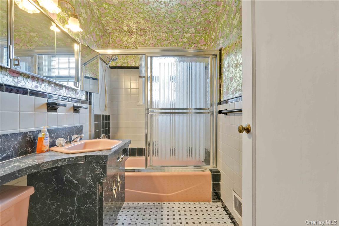 84-92 Austin Street Queens, NY 11415 - Photo 20 of 40 a bathroom with a tub and a shower