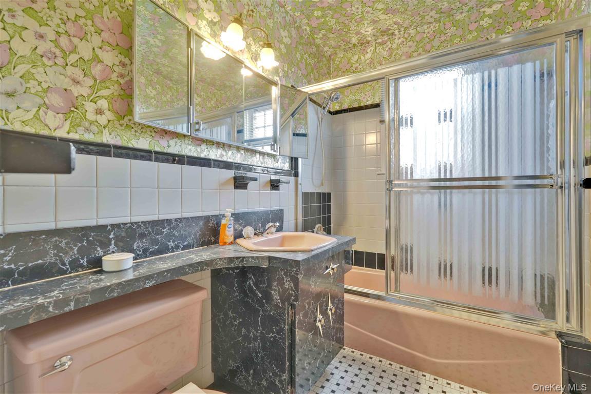 84-92 Austin Street Queens, NY 11415 - Photo 21 of 40 a kitchen with a sink a stove and a refrigerator