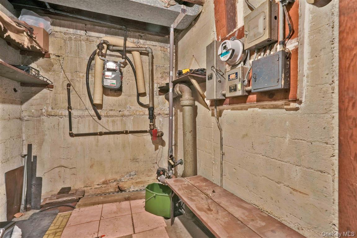 84-92 Austin Street Queens, NY 11415 - Photo 25 of 40 a bathroom with a granite countertop sink a mirror and bathtub