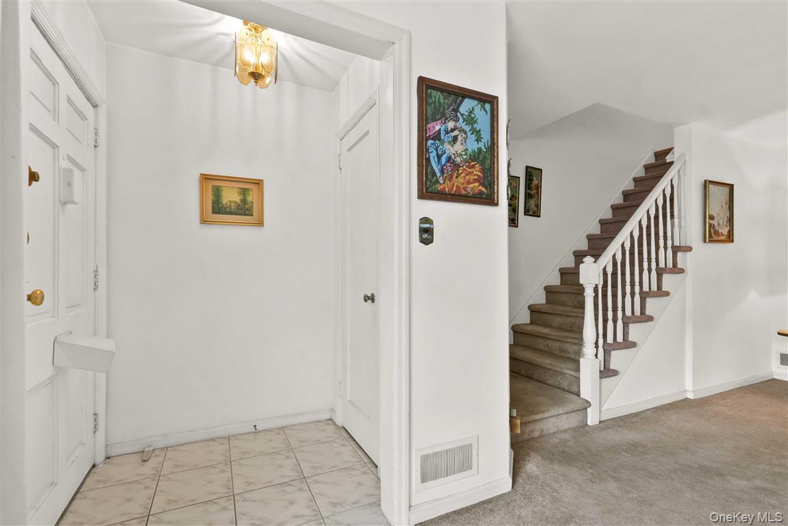 84-92 Austin Street Queens, NY 11415 - Photo 3 of 40 a view of a hallway with paintings on the wall