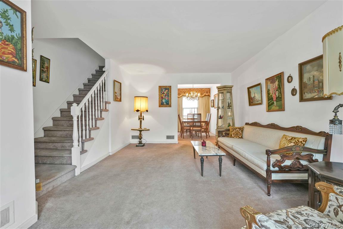 84-92 Austin Street Queens, NY 11415 - Photo 5 of 40 a living room with furniture and a window