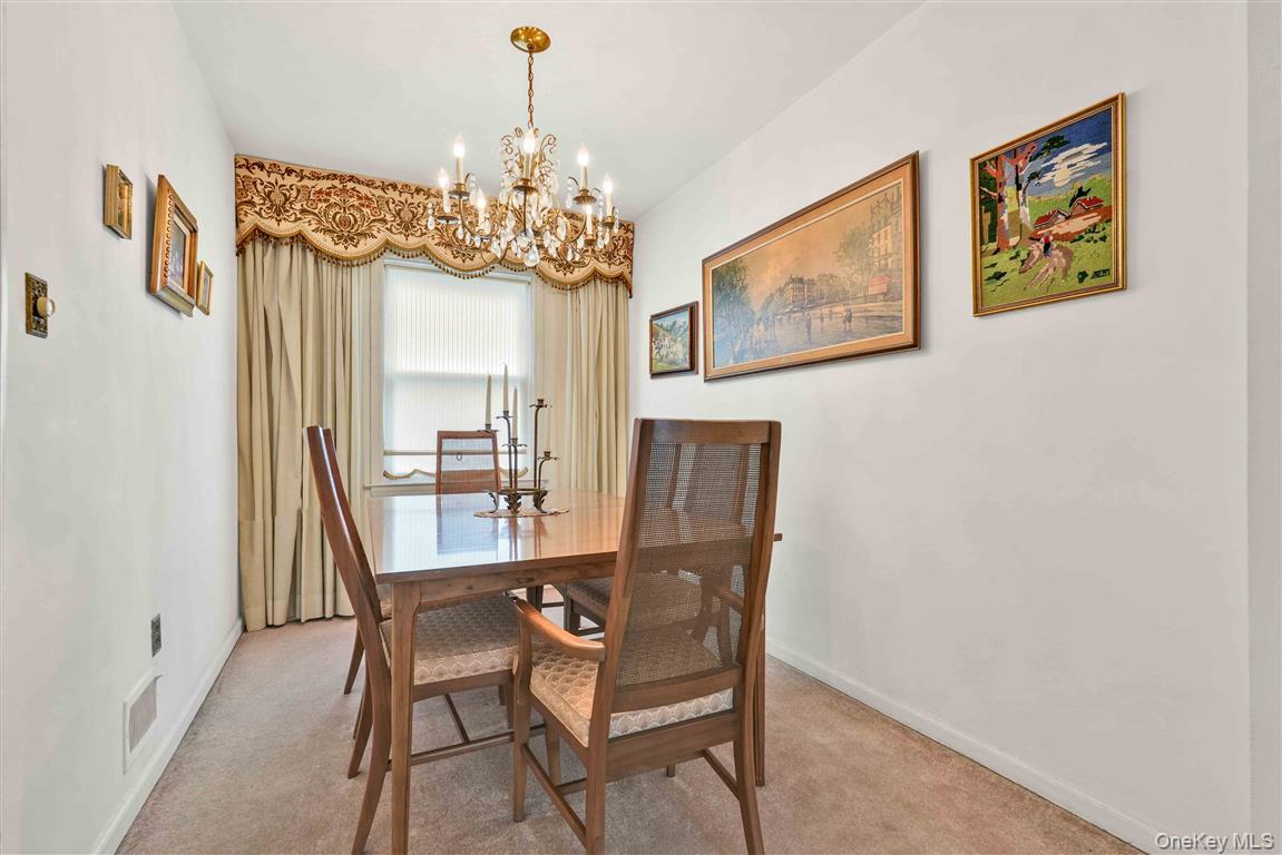 84-92 Austin Street Queens, NY 11415 - Photo 8 of 40 a view of a dining room with furniture a chandelier and wooden floor