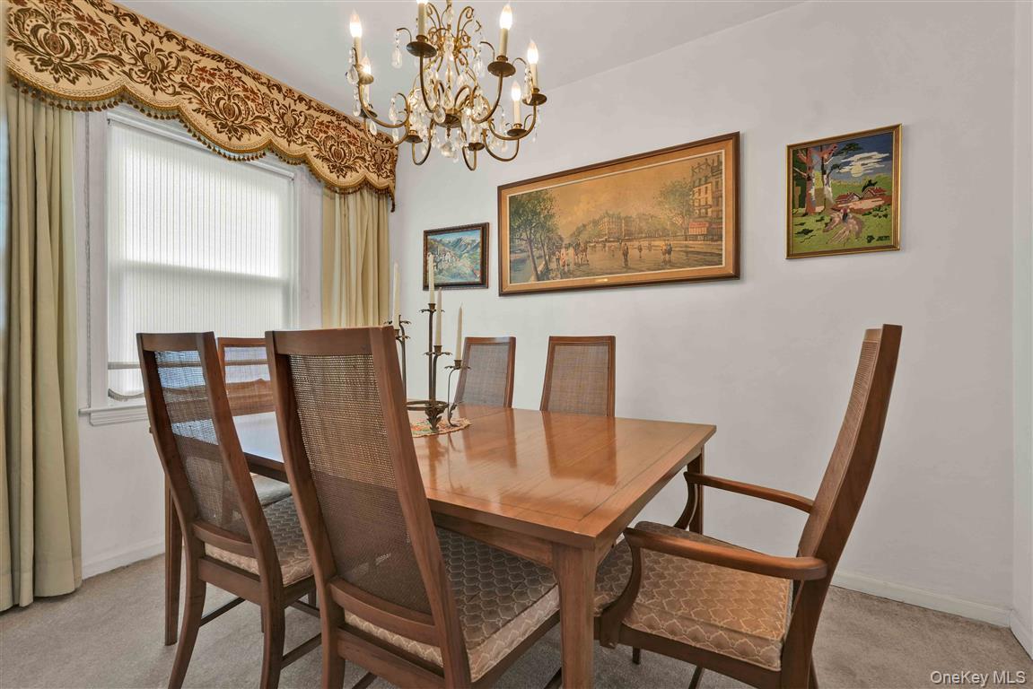 84-92 Austin Street Queens, NY 11415 - Photo 9 of 40 a view of a dining room with furniture and chandelier