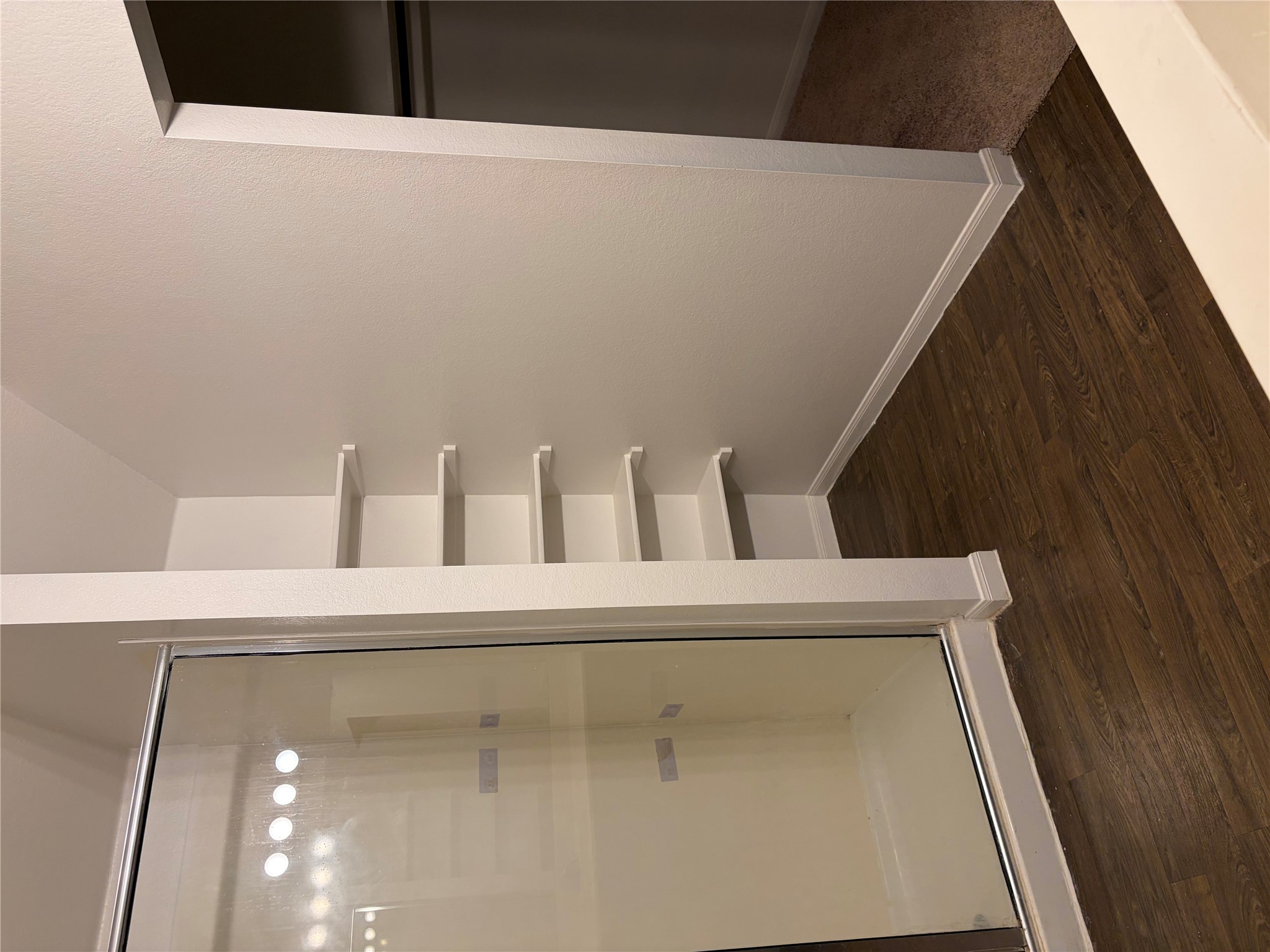 137 Rafe Court Kyle, TX 78640 - Photo 10 of 36 A well-appointed bathroom area offers convenient built-in shelving and a sleek shower enclosure in Master’s Suite.