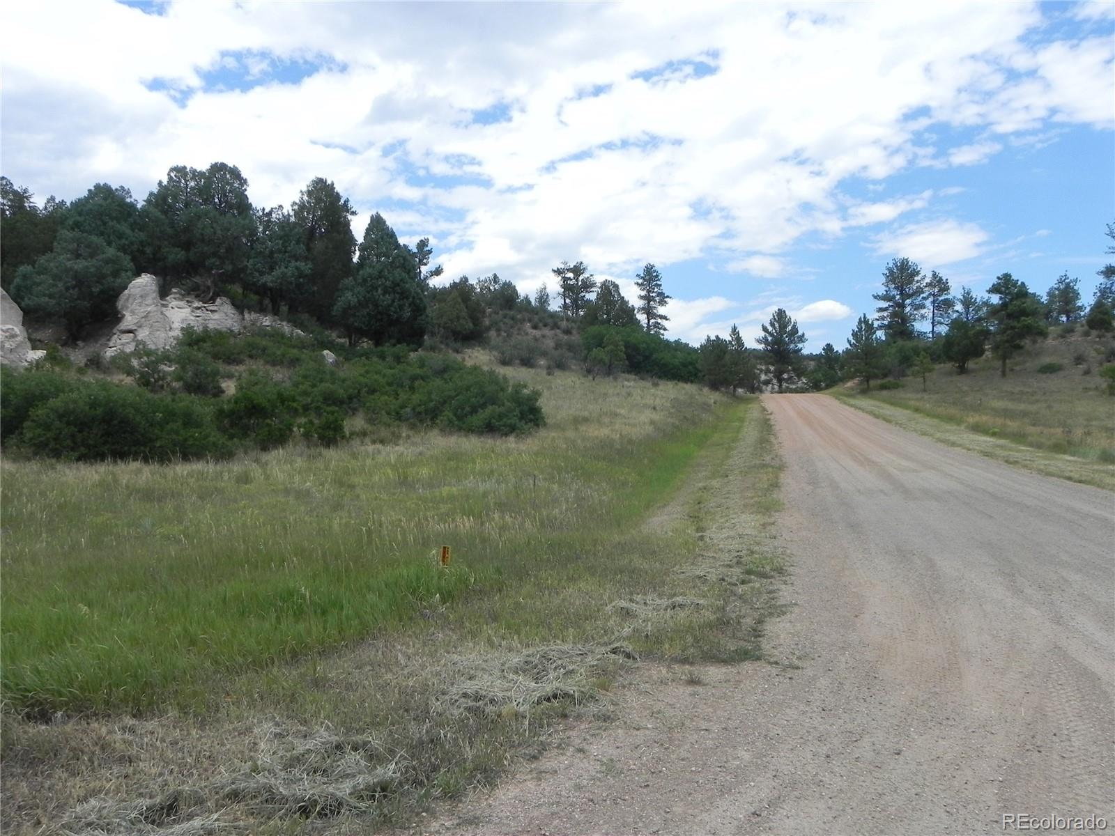 7749 Inca Road Larkspur, CO 80118 - Photo 11 of 49 a view of a lake view with houses in back