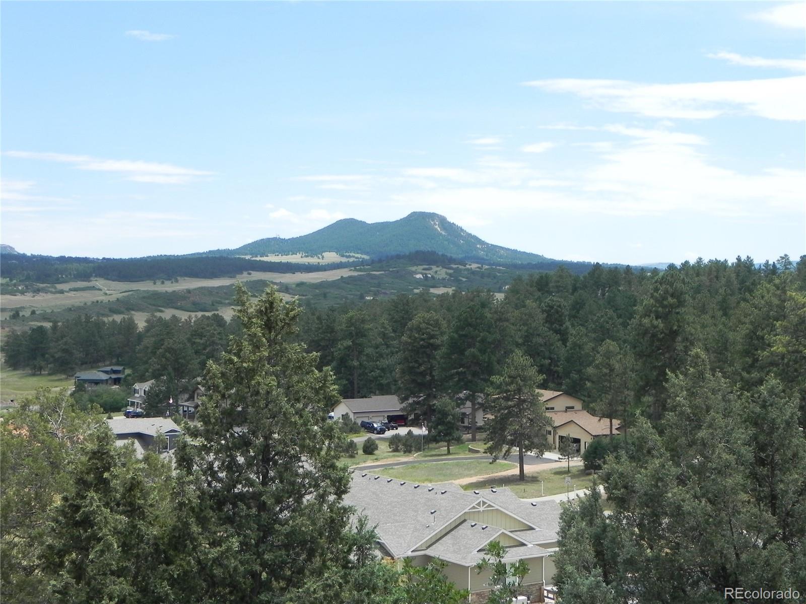 7749 Inca Road Larkspur, CO 80118 - Photo 23 of 49 a view of a town with mountains in the background