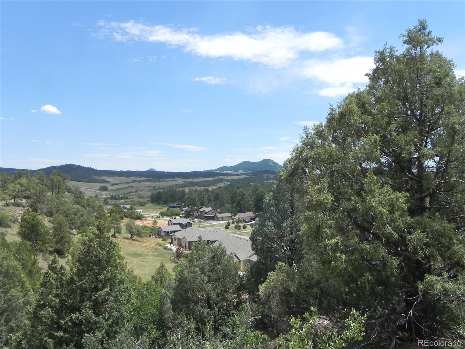 7749 Inca Road Larkspur, CO 80118 - Photo 27 of 49 a view of a city with mountains in the background