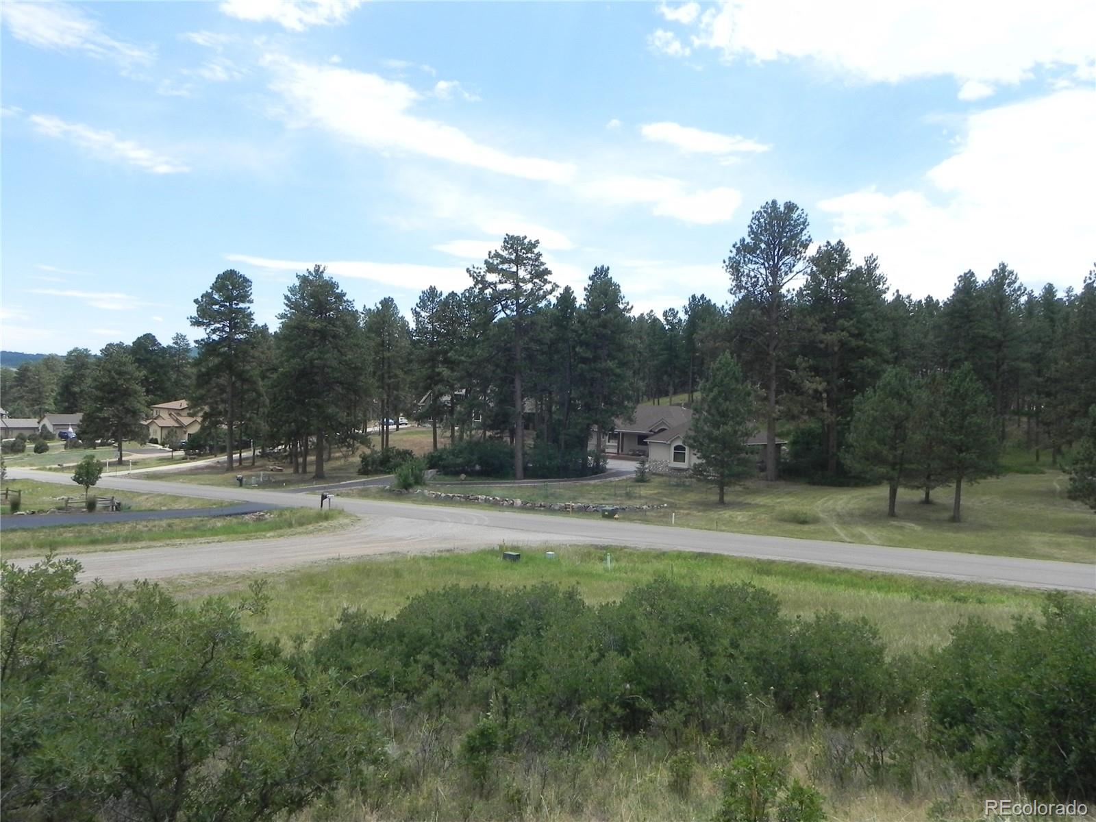 7749 Inca Road Larkspur, CO 80118 - Photo 40 of 49 a view of outdoor space with green field and trees