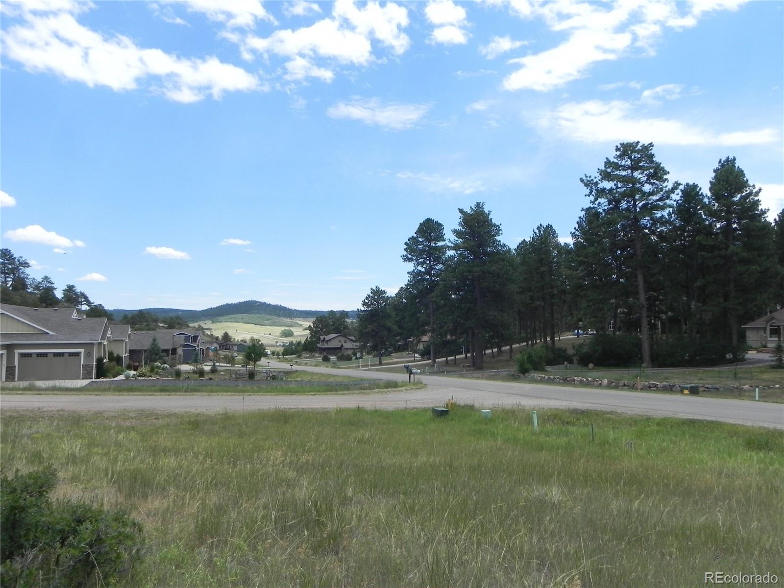 7749 Inca Road Larkspur, CO 80118 - Photo 44 of 49 a view of outdoor space with green field and trees around