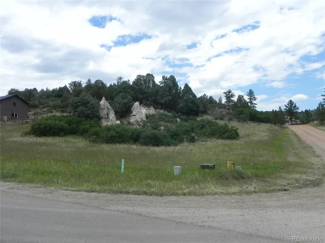 an aerial view of a houses with a yard