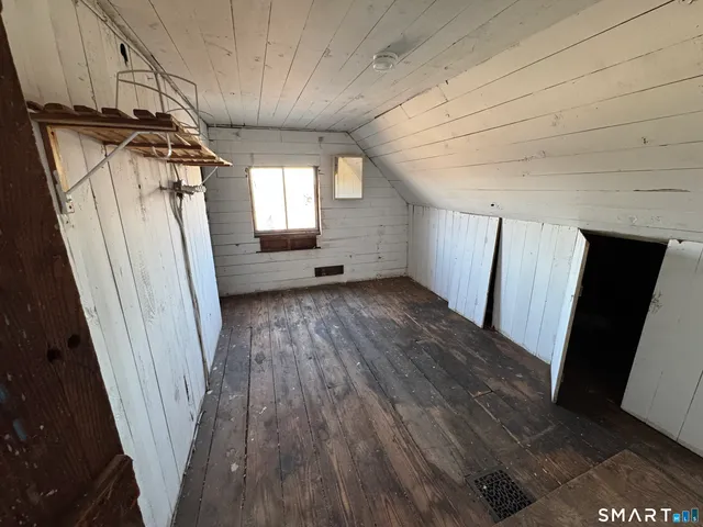 a view of hallway with wooden floor and stairs