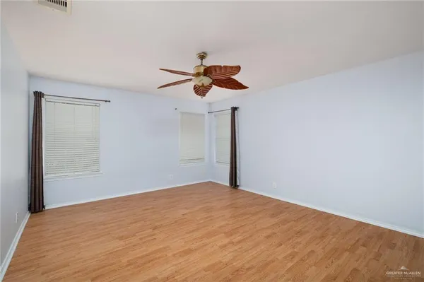 a view of an empty room and cabinet with a window