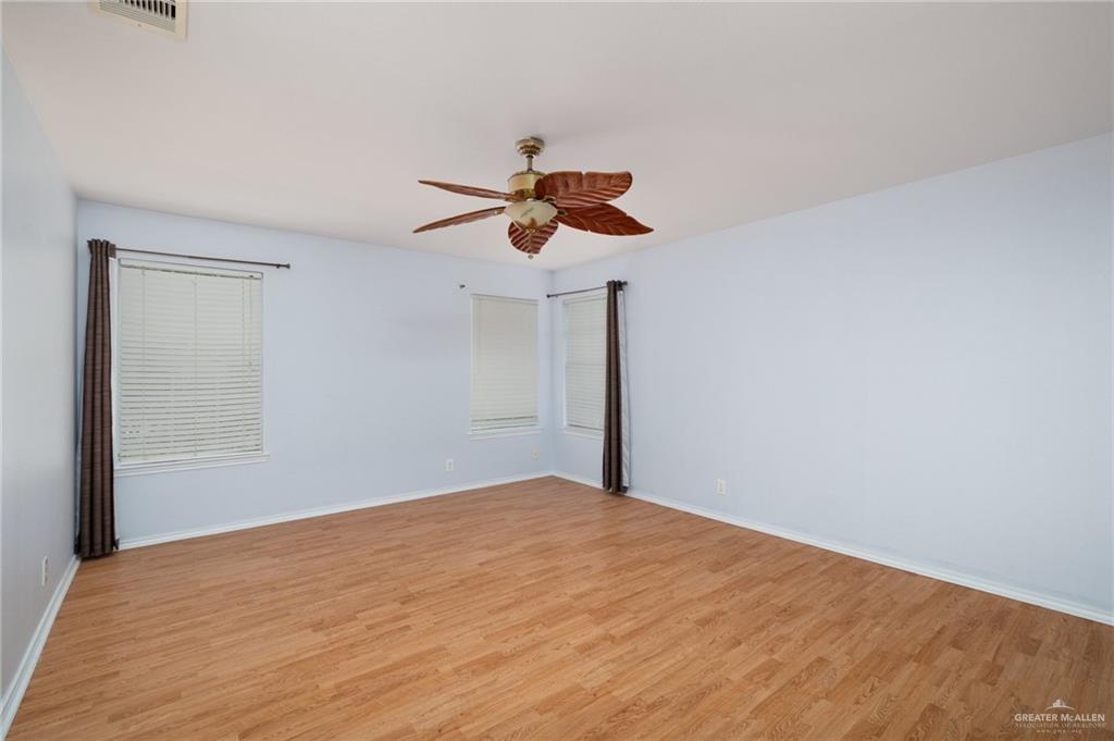 7105 North 40th Street McAllen, TX 78504 - Photo 8 of 13 a view of an empty room and cabinet with a window