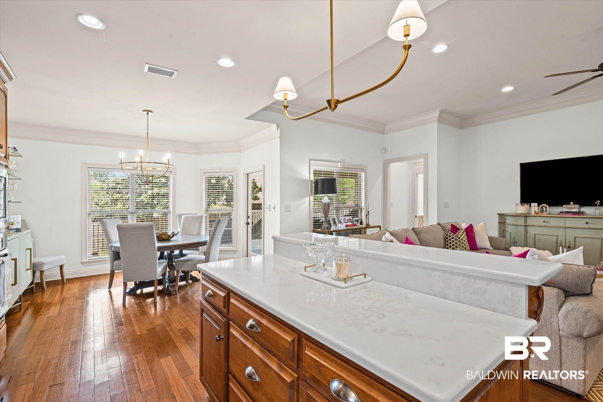 3459 Rue Royal Mobile, AL 36693 - Photo 9 of 31 Open-concept living space featuring wood-finish flooring, recessed lighting, and crown molding