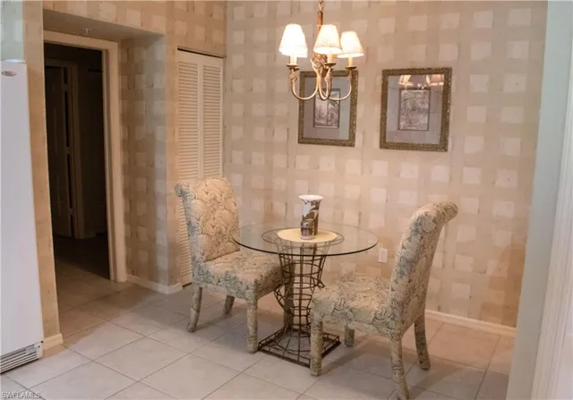 a view of a dining room with furniture and chandelier