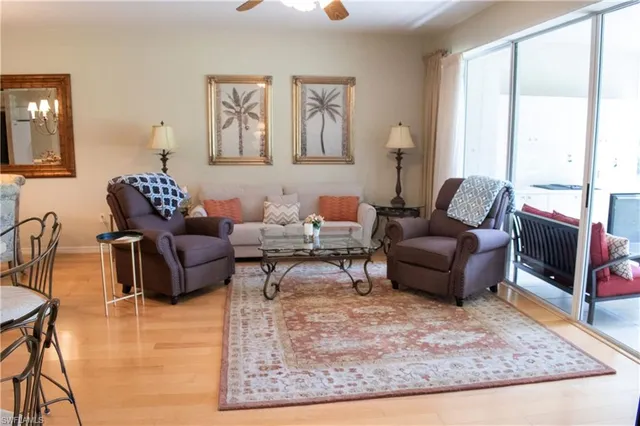 a living room with furniture rug and window