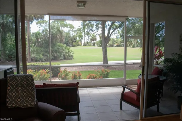 a view of two chairs and a table in a balcony