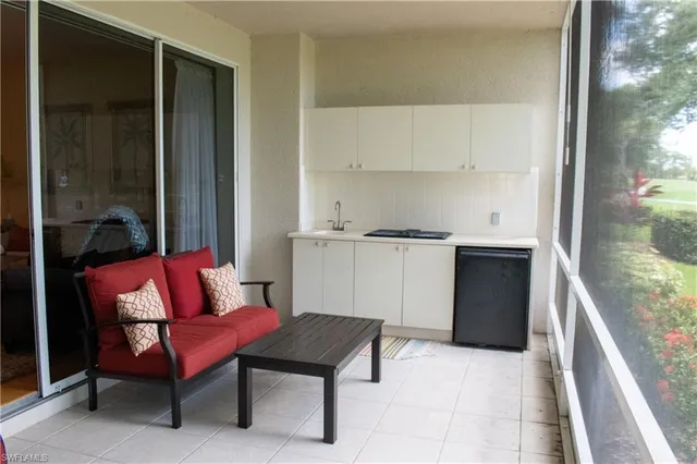 a living room with furniture a rug and a table