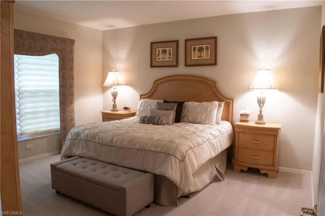 a bedroom with a bed and a lamp