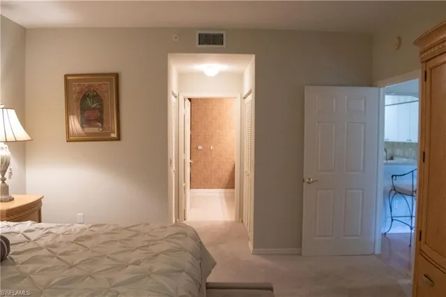 a bedroom with a bed and a lamp