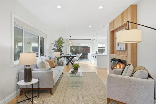 a living room with fireplace furniture and a chandelier