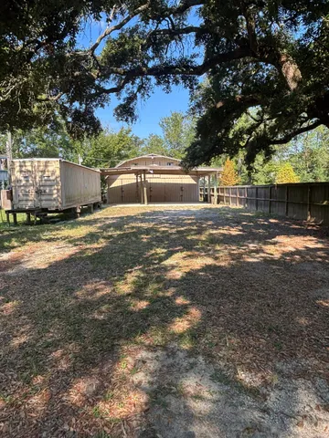 a view of a yard with a tree