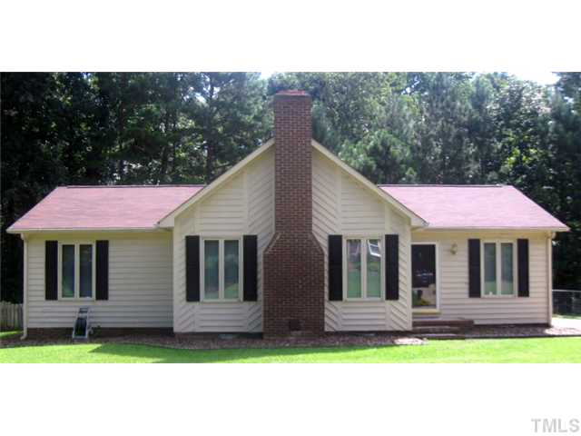 7712 Prospector Place Raleigh, NC 27615 - Photo 1 of 16 a front view of a house with a garden and yard