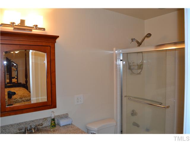 7712 Prospector Place Raleigh, NC 27615 - Photo 12 of 16 a bathroom with a shower and a mirror