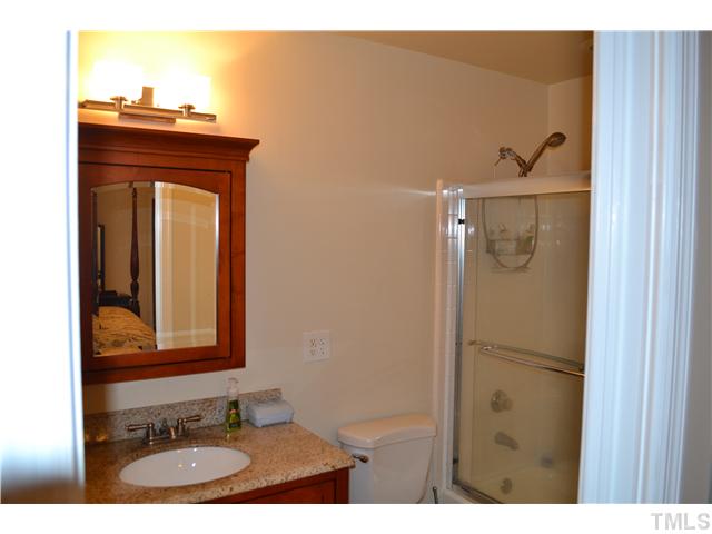 7712 Prospector Place Raleigh, NC 27615 - Photo 13 of 16 a bathroom with a sink and mirror