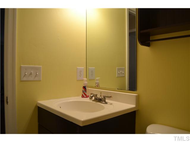 7712 Prospector Place Raleigh, NC 27615 - Photo 15 of 16 a bathroom with a sink and a mirror
