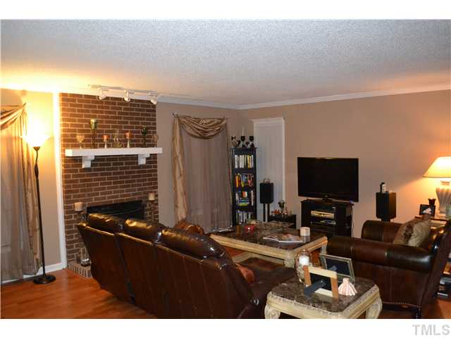 7712 Prospector Place Raleigh, NC 27615 - Photo 5 of 16 a living room with furniture and a flat screen tv
