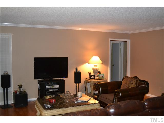 7712 Prospector Place Raleigh, NC 27615 - Photo 6 of 16 a living room with furniture and a flat screen tv