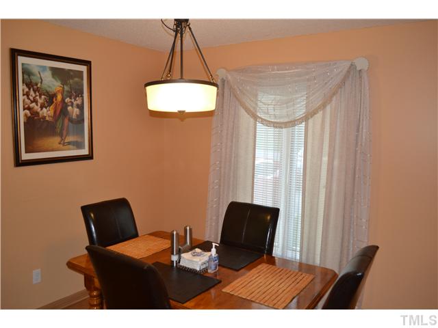 7712 Prospector Place Raleigh, NC 27615 - Photo 7 of 16 a balcony with table and chair