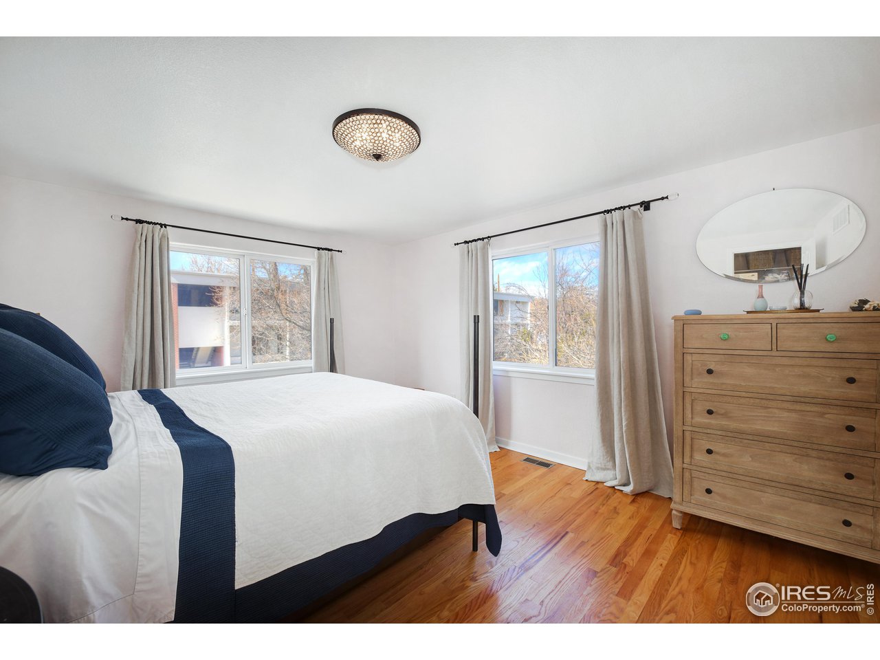 2701 Mapleton Avenue, Unit C Boulder, CO 80304 - Photo 18 of 34 a bedroom with a bed and a dresser