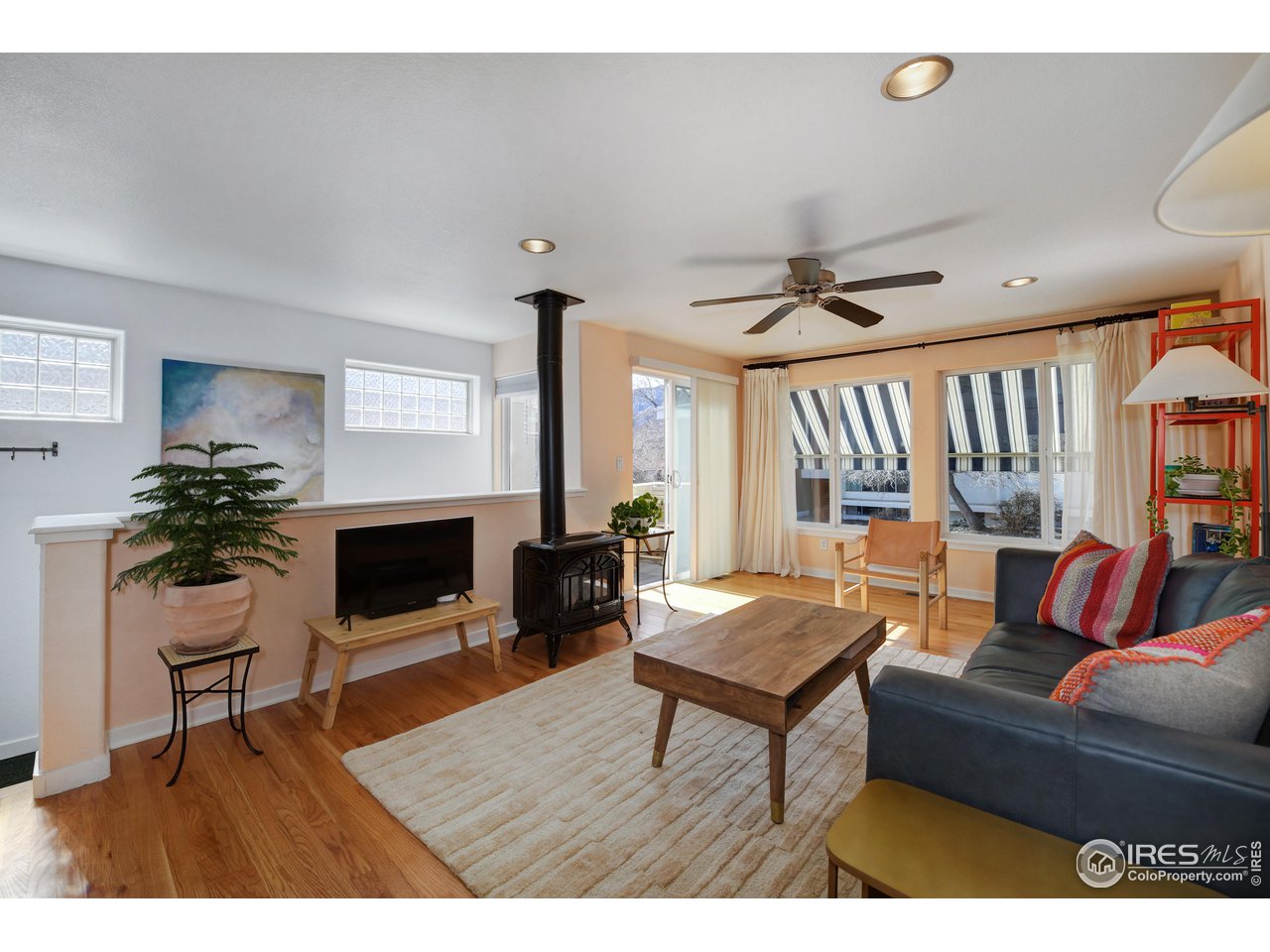 2701 Mapleton Avenue, Unit C Boulder, CO 80304 - Photo 6 of 34 a living room with furniture a fireplace and a potted plant