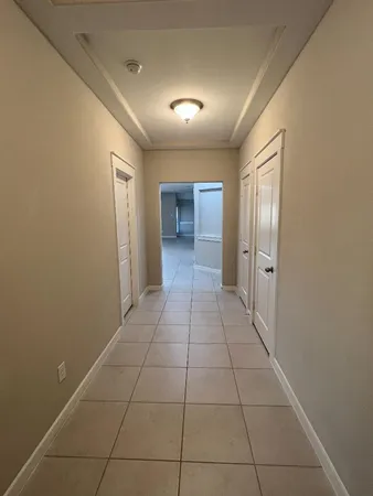 a view of a hallway to rooms