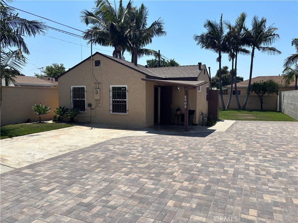 8808 Paseo Street Paramount, CA 90723 - Photo 13 of 15 a house with palm tree in front of it