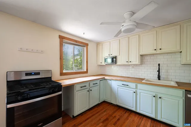 a kitchen with a sink stove and cabinets