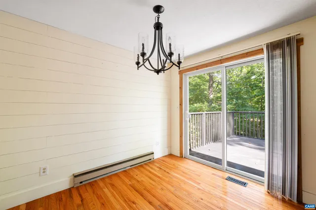 a view of a room with wooden floor and windows