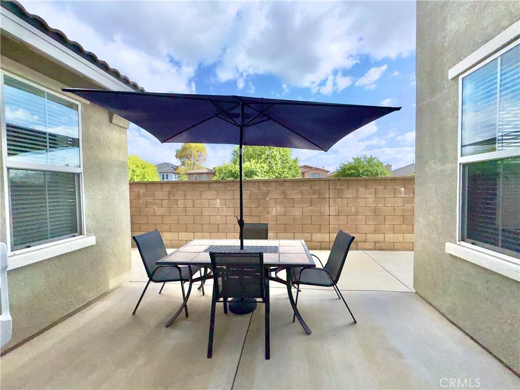 11265 Runyan Road Beaumont, CA 92223 - Photo 29 of 138 a patio with wooden floor table and chairs
