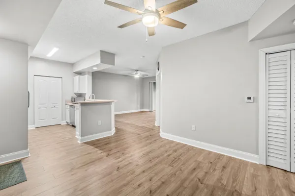 a view of a kitchen with a sink and wooden floor