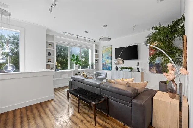 a living room with furniture tv and a large window