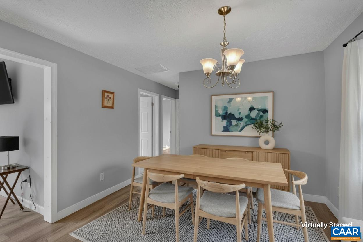 673 Cedar Lane Road Palmyra, VA 22963 - Photo 20 of 47 a dining room with furniture and chandelier