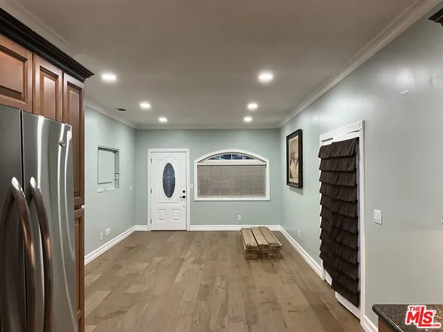 a view of empty room with a refrigerator and washer