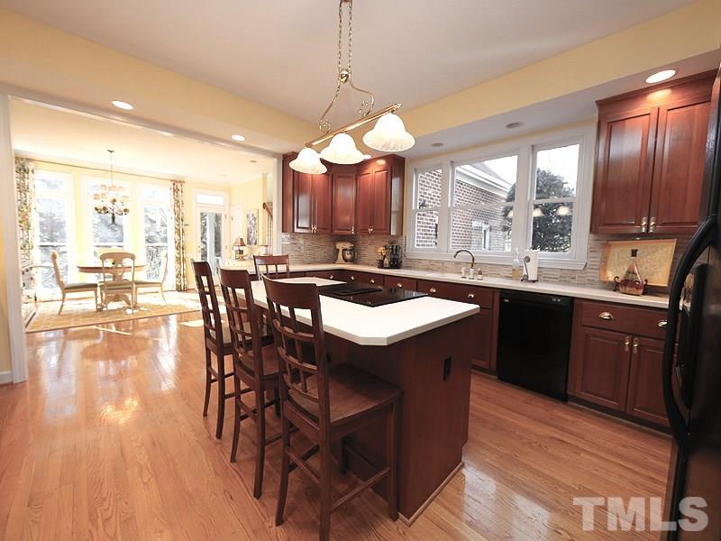 8808 Ross Court Raleigh, NC 27613 - Photo 2 of 25 a kitchen with a sink counter and chairs