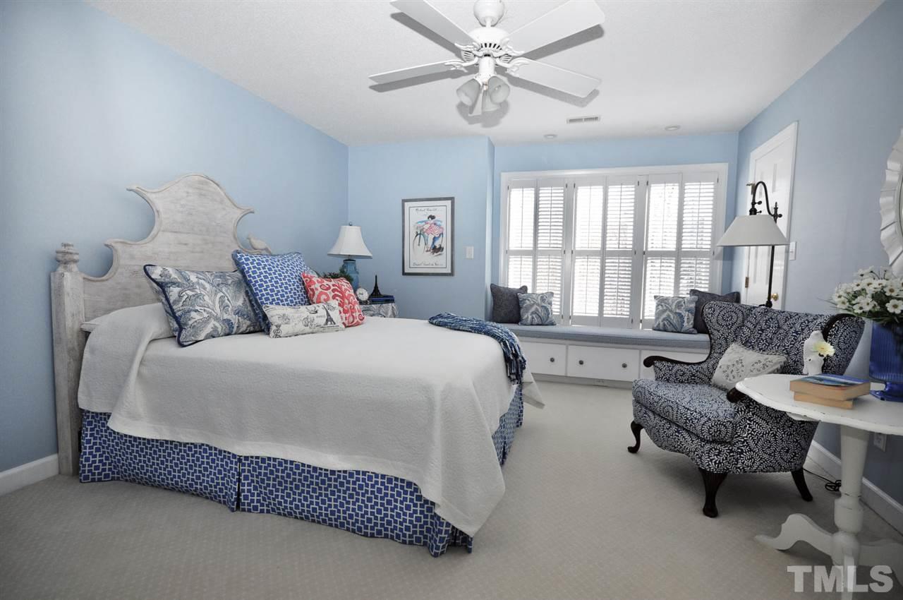 8808 Ross Court Raleigh, NC 27613 - Photo 12 of 25 a spacious bedroom with a bed couch and a large window