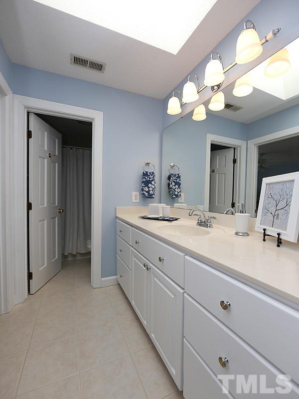 8808 Ross Court Raleigh, NC 27613 - Photo 13 of 25 a bathroom with a sink vanity and a mirror